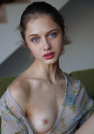 18 year old girl Katie Lewis stands naked after undressing in her bedroom